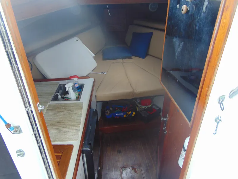 Slide: The Image of Interior of 1987 Black Watch Sportfish boat with beige seating and small kitchenette. - 5