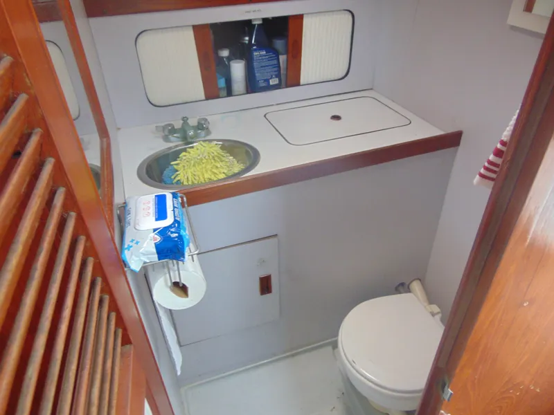 Slide: The Image of 1987 Black Watch Sportfish bathroom with sink, toilet, and storage. - 6