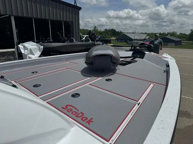 Slide: The Image of 2024 Xpress Boats H18 with SeaDek flooring, docked outdoors. - 5
