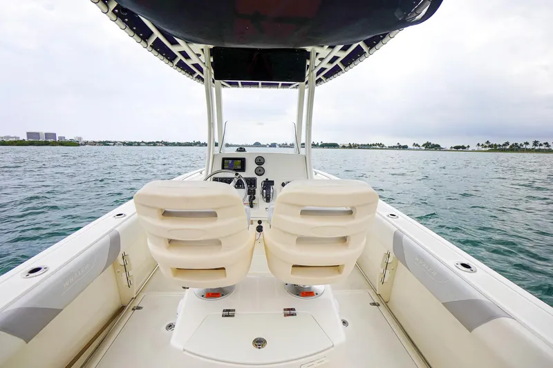 Slide: The Image of 2015 Boston Whaler 220 Outrage boat interior with dual seats and ocean view. - 16