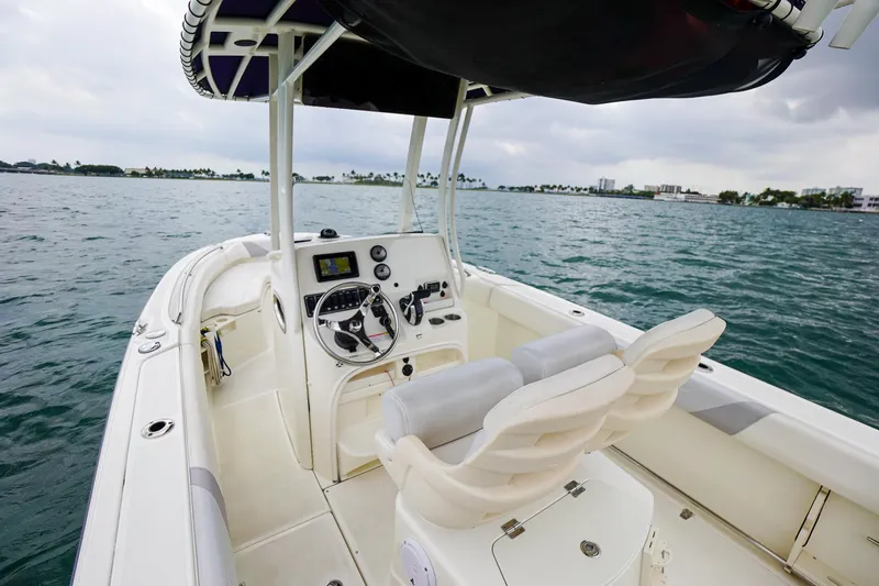 Slide: The Image of 2015 Boston Whaler 220 Outrage boat interior with steering console and seating. - 17