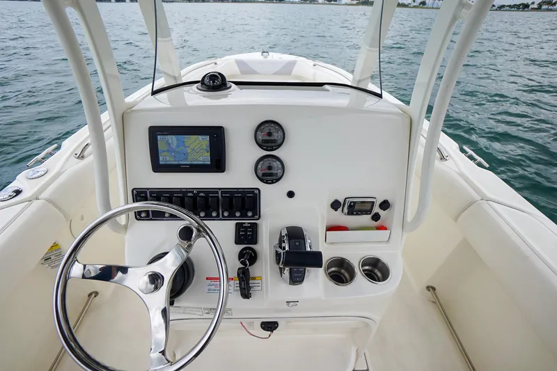 Slide: The Image of 2015 Boston Whaler 220 Outrage boat console with steering wheel and navigation system. - 21