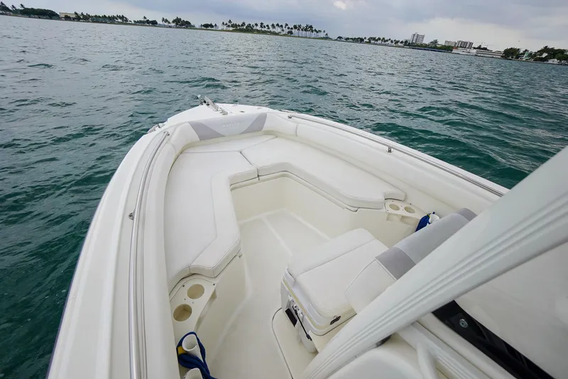 Slide: The Image of 2015 Boston Whaler 220 Outrage boat interior with seating, on open water. - 23