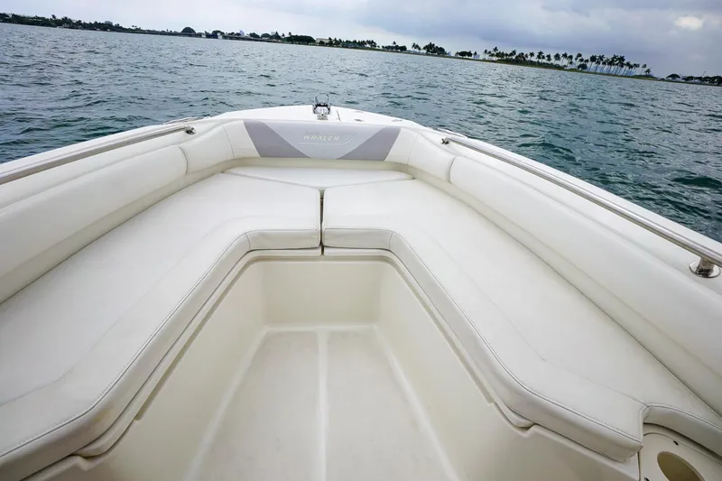 Slide: The Image of 2015 Boston Whaler 220 Outrage boat bow seating area on the water. - 24