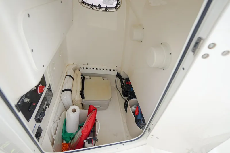 Slide: The Image of 2015 Boston Whaler 220 Outrage cabin interior with storage and equipment. - 28