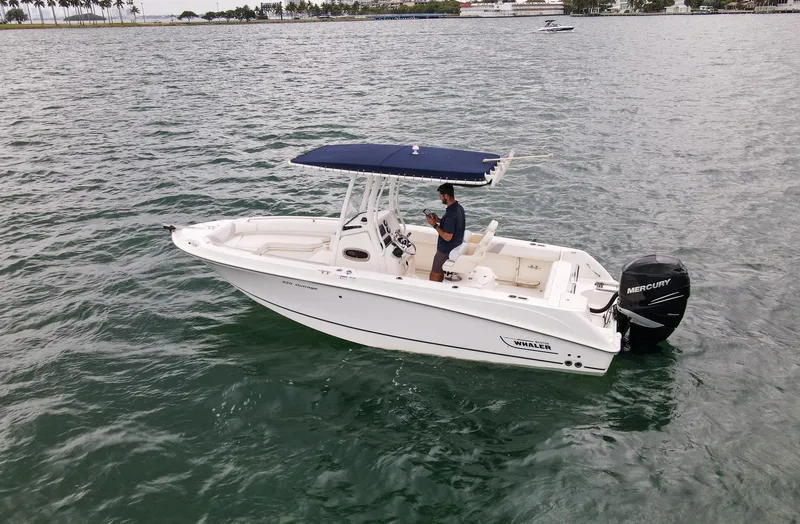 Slide: The Image of 2015 Boston Whaler 220 Outrage boat on water with Mercury outboard engine. - 6