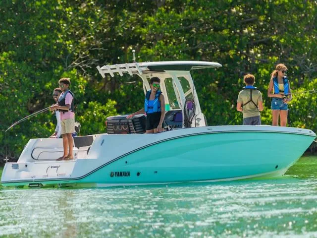 Slide: The Image of 2024 Yamaha Boats 252 FSH Sport on water with people fishing. - 2