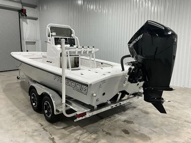 Slide: The Image of 2024 Freedom Boats 23' Warrior on trailer in indoor storage. - 10