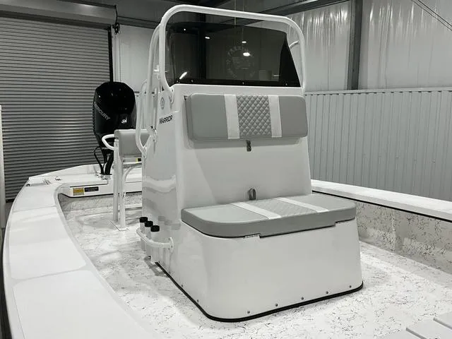 Slide: The Image of 2024 Freedom Boats 23' Warrior center console in a showroom. - 12