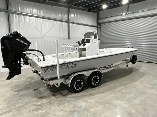 Slide: The Image of 2024 Freedom Boats 23' Warrior in a garage, side view. - 13
