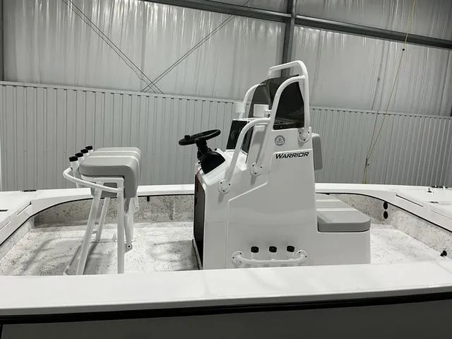 Slide: The Image of 2024 Freedom Boats 23' Warrior center console in a warehouse. - 6