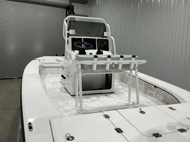 Slide: The Image of 2024 Freedom Boats 23' Warrior in storage, showcasing center console and rod holders. - 8