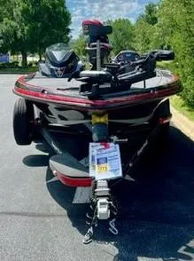 Slide: The Image of 2024 Ranger Z521R Ranger Cup Equipped boat on trailer in outdoor setting. - 2