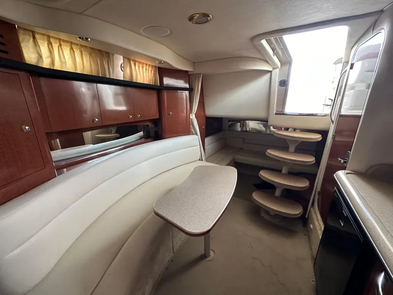 Slide: The Image of Interior of 2003 Sea Ray 340 Sundancer yacht with seating, table, and steps. - 13