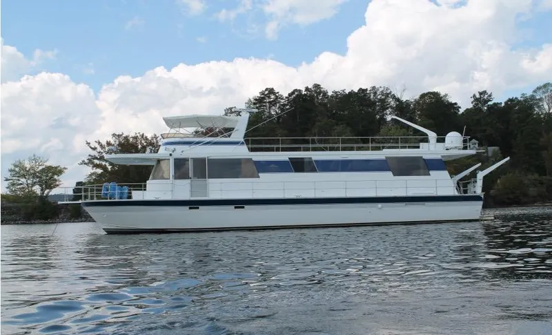 Slide: The Image of 1995 Pluckebaum Coastal Cruiser yacht on calm water with trees in the background. - 1