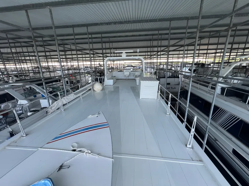 Slide: The Image of 1995 Pluckebaum Coastal Cruiser docked in a covered marina. - 13