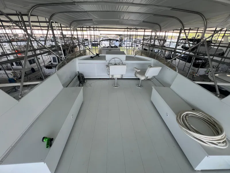 Slide: The Image of 1995 Pluckebaum Coastal Cruiser upper deck with helm, seating, and storage. - 14