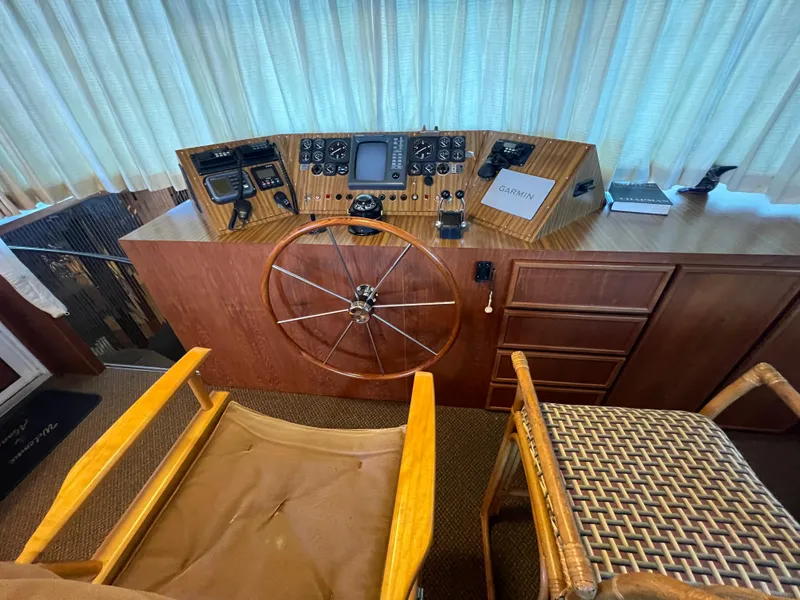 Slide: The Image of 1995 Pluckebaum Coastal Cruiser helm with wooden wheel, navigation instruments, and Garmin GPS. - 17
