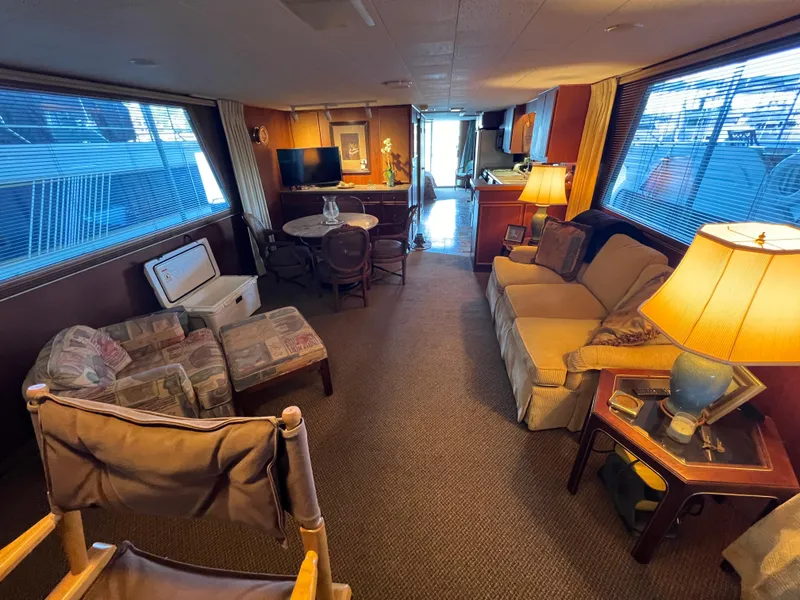 Slide: The Image of Interior of a 1995 Pluckebaum Coastal Cruiser with cozy seating and a dining area. - 18