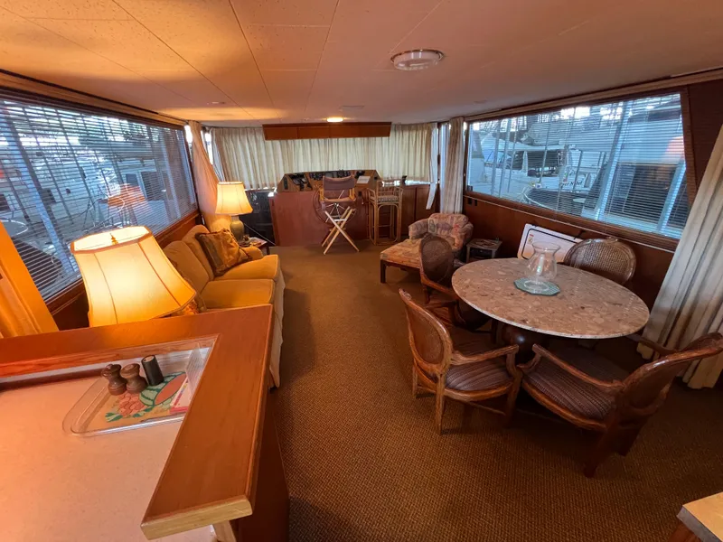 Slide: The Image of Interior of a 1995 Pluckebaum Coastal Cruiser with cozy seating and dining area. - 19