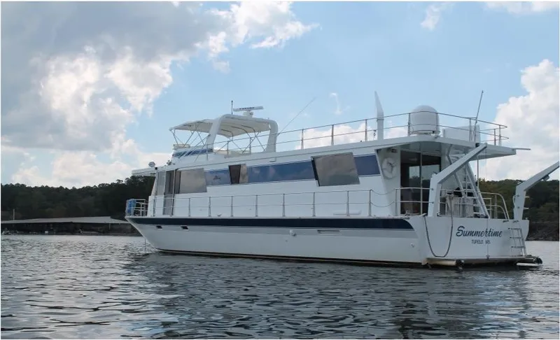 Slide: The Image of 1995 Pluckebaum Coastal Cruiser yacht named Summertime on a calm lake under a partly cloudy sky. - 2