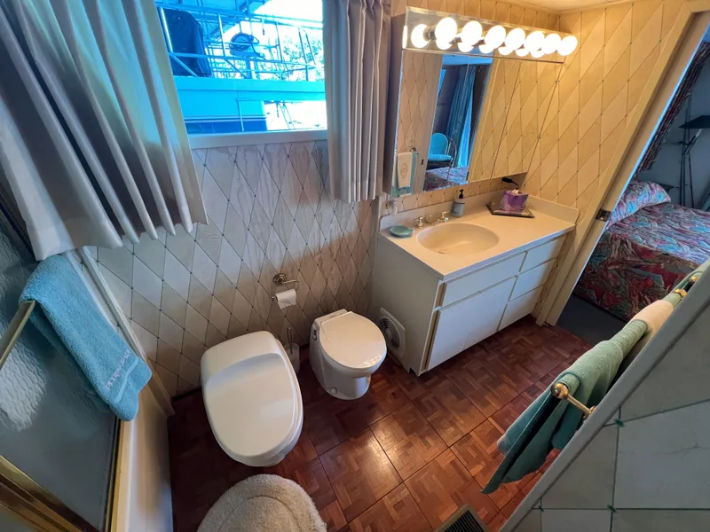 Slide: The Image of Bathroom interior of a 1995 Pluckebaum Coastal Cruiser yacht with vanity, toilet, and shower. - 23