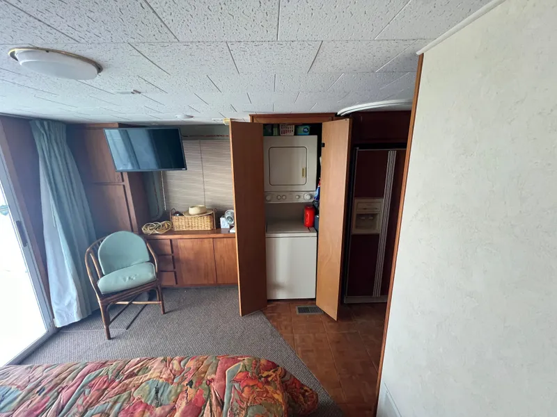 Slide: The Image of Interior of a 1995 Pluckebaum Coastal Cruiser with laundry area and TV. - 24