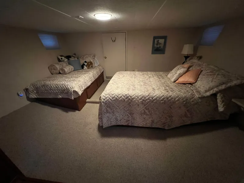 Slide: The Image of Cozy bedroom in a 1995 Pluckebaum Coastal Cruiser with twin and queen beds. - 25