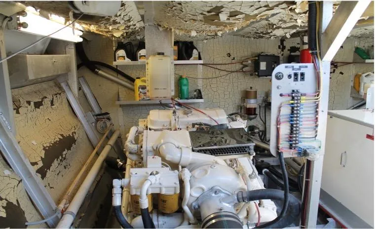 Slide: The Image of 1995 Pluckebaum Coastal Cruiser engine room with peeling paint and maintenance equipment. - 32