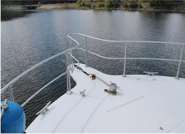 Slide: The Image of Bow of a 1995 Pluckebaum Coastal Cruiser on calm water. - 4