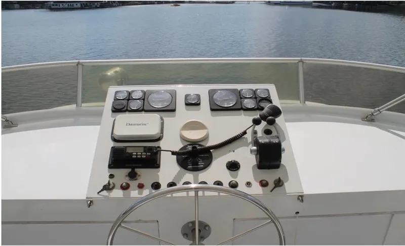 Slide: The Image of Control panel of a 1995 Pluckebaum Coastal Cruiser boat with water in the background. - 7