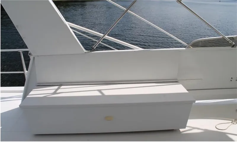 Slide: The Image of 1995 Pluckebaum Coastal Cruiser deck with white storage bench and railing. - 8