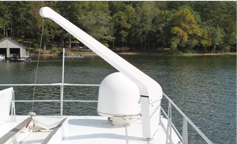 Slide: The Image of 1995 Pluckebaum Coastal Cruiser on a serene lake with lush green trees. - 9