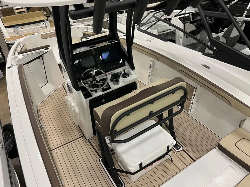 Slide: The Image of 2024 Yamaha Boats 255 FSH Sport H interior, featuring helm station and seating. - 4