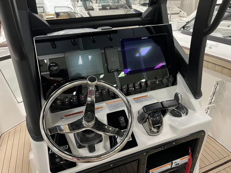 Slide: The Image of 2024 Yamaha Boats 255 FSH Sport H helm with steering wheel and control panel. - 5