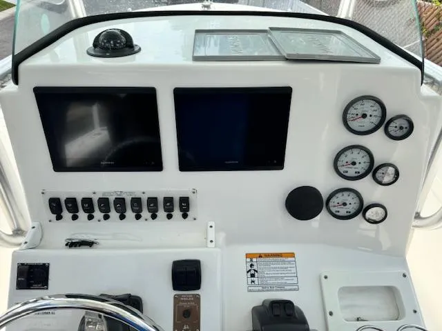 Slide: The Image of 2013 Sea Fox 286 CC boat dashboard with dual screens and gauges. - 14