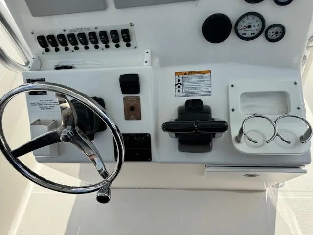 Slide: The Image of 2013 Sea Fox 286 CC boat dashboard with steering wheel and controls. - 16