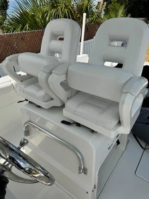 Slide: The Image of 2013 Sea Fox 286 CC boat with dual white captain's chairs. - 20