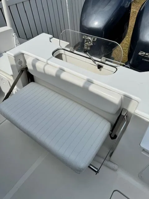 Slide: The Image of 2013 Sea Fox 286 CC boat with foldable white bench seat and dual outboard motors. - 25