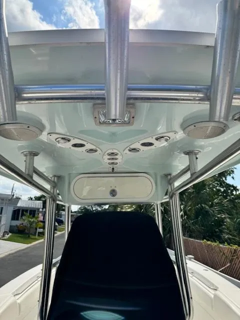 Slide: The Image of 2013 Sea Fox 286 CC center console boat with T-top and rod holders. - 29