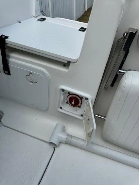 Slide: The Image of 2013 Sea Fox 286 CC boat interior with storage compartments and control panel. - 31