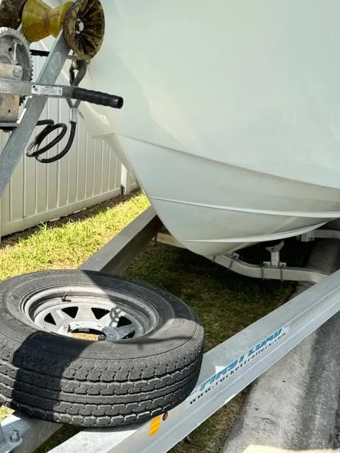 Slide: The Image of 2013 Sea Fox 286 CC boat on a trailer with a spare tire. - 35