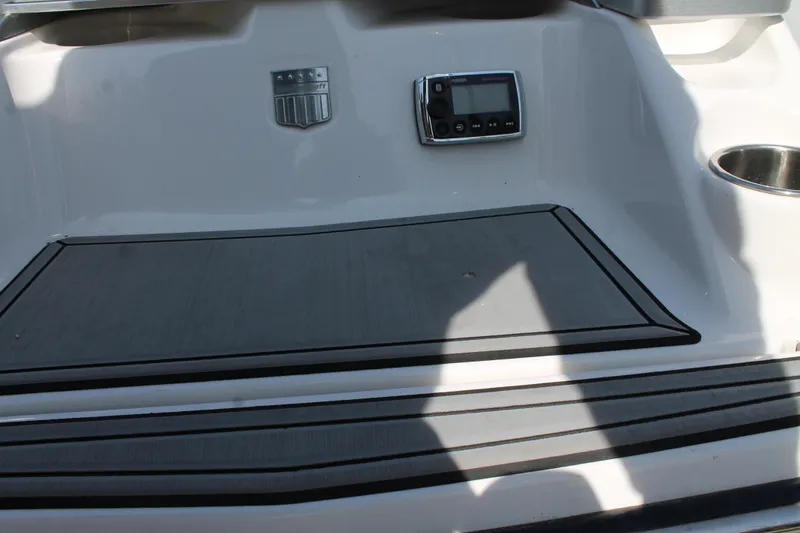 Slide: The Image of 2016 MasterCraft X26 boat interior with control panel and non-slip flooring. - 16