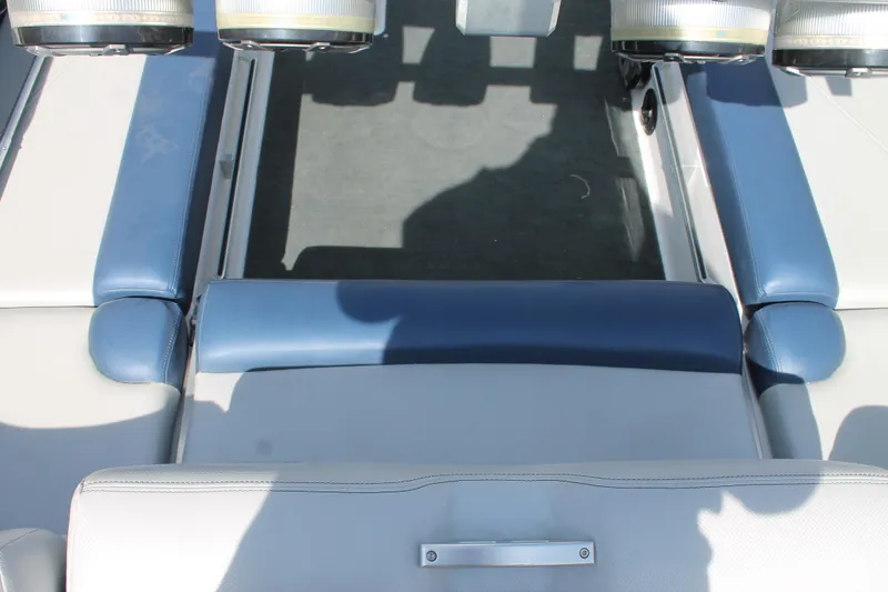 Slide: The Image of 2016 MasterCraft X26 boat interior seating area with blue and white upholstery. - 19