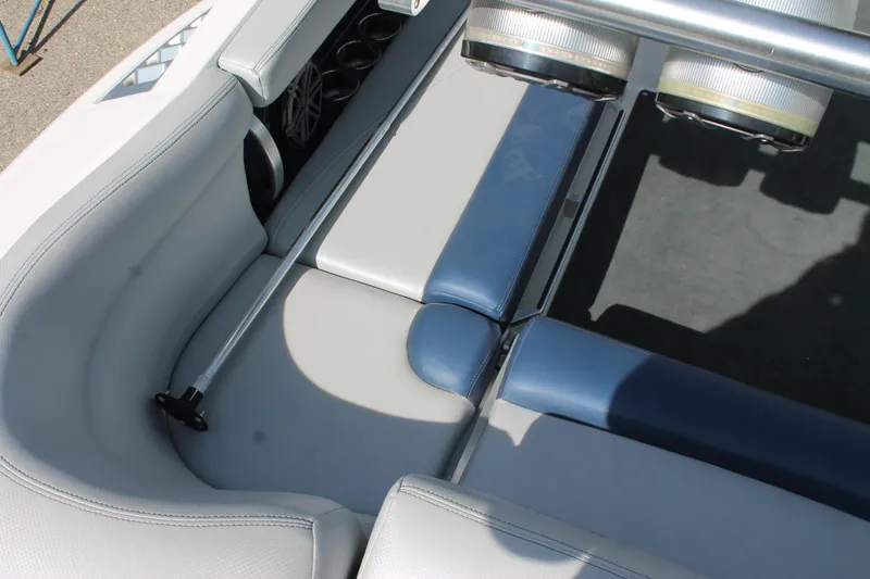 Slide: The Image of 2016 MasterCraft X26 boat interior seating area with gray and blue upholstery. - 21