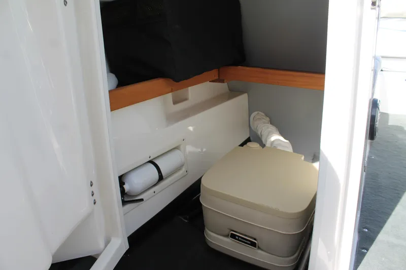 Slide: The Image of 2016 MasterCraft X26 boat interior with portable toilet. - 24