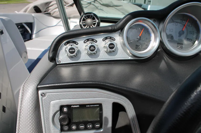 Slide: The Image of 2016 MasterCraft X26 boat dashboard with gauges and Fusion audio system. - 26