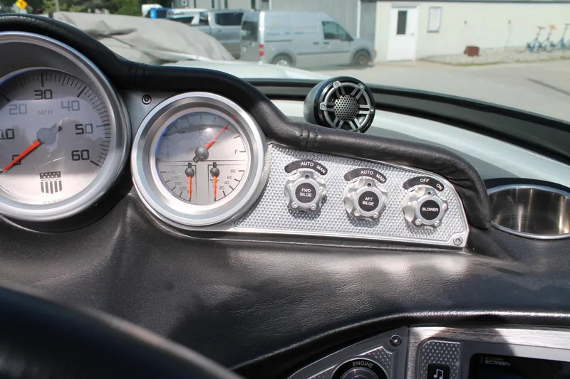 Slide: The Image of 2016 MasterCraft X26 boat dashboard with speedometer, tachometer, and control switches. - 27