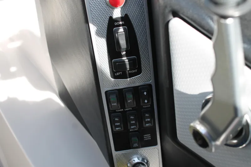 Slide: The Image of 2016 MasterCraft X26 boat control panel with switches and joystick. - 30