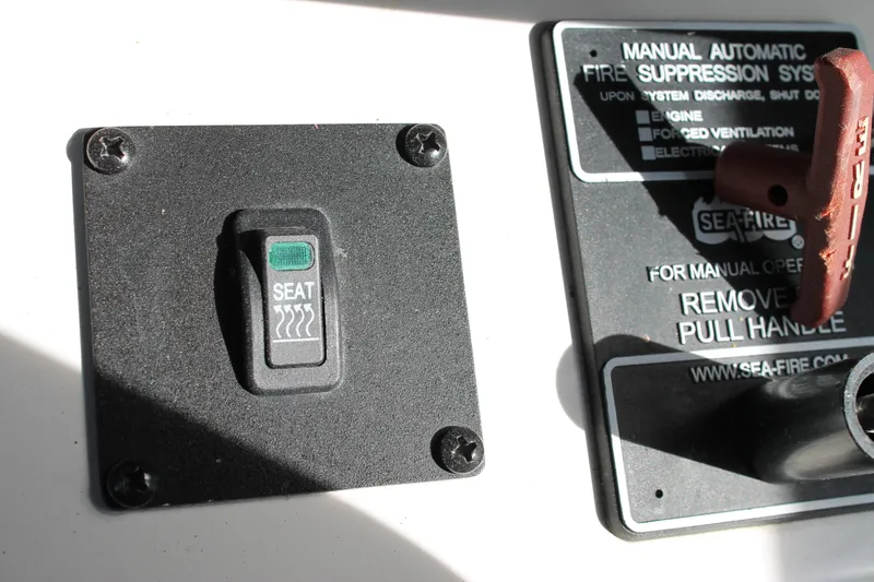 Slide: The Image of MasterCraft X26 2016 seat heater switch and fire suppression system control. - 32